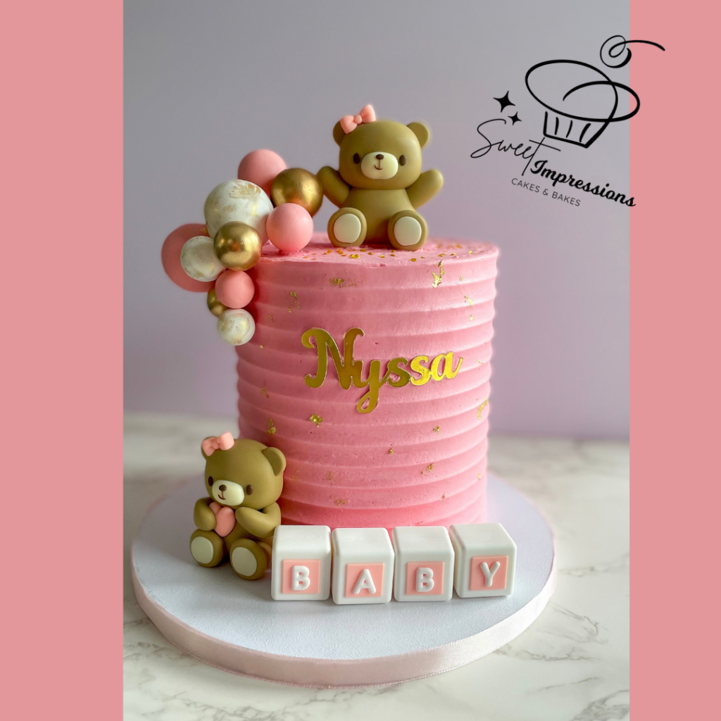 A baby pink baby shower cake.