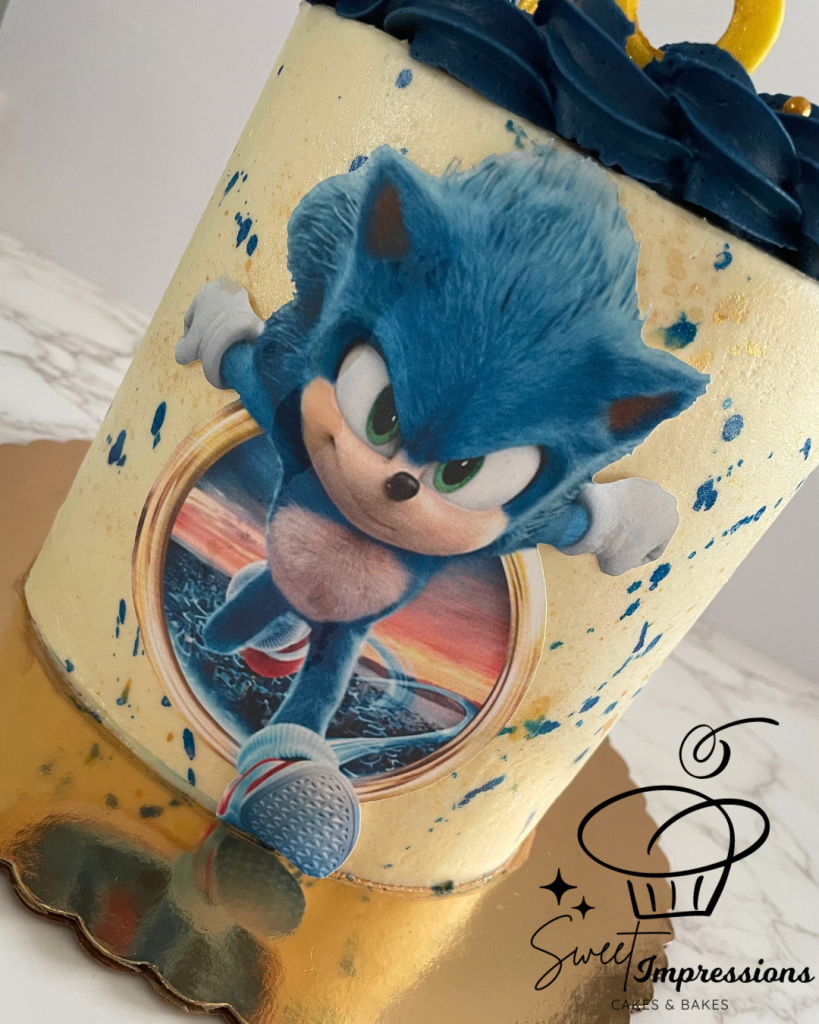 sonic movie cake with blue and gold splashes and gold rings